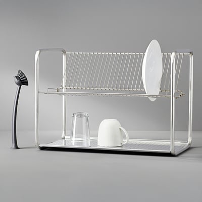Silver RINNIG kitchen rack holds dish, cup; tall brush left.