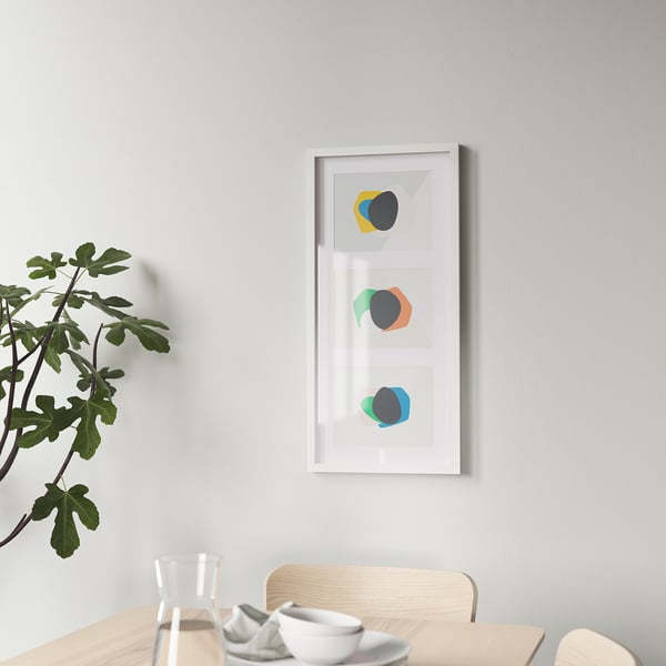 Wooden dining table with abstract wall art and plant.