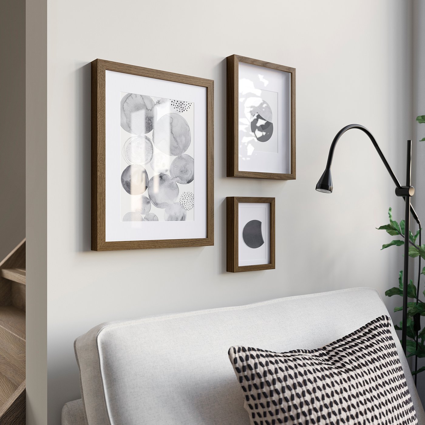 Modern RÖDALM frames above cosy chair with pillows; serene reading spot.