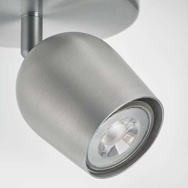 Modern, adjustable ceiling spotlight with sleek, metallic finish. Emits focused, bright light.