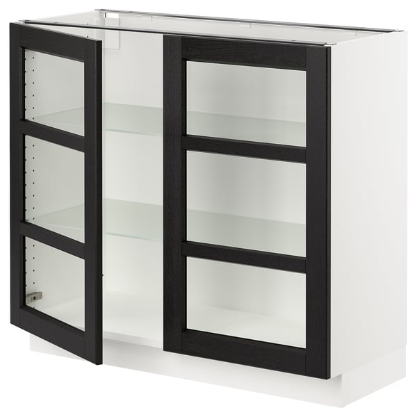 A white SEKTION kitchen cabinet with black-stained glass doors and three glass shelves. It has a modern, sleek design with bevelled edges.