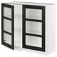 A white SEKTION kitchen cabinet with black-stained glass doors and three glass shelves. It has a modern, sleek design with bevelled edges.