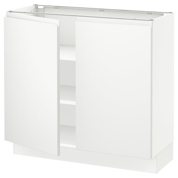 Modern white kitchen cabinet with sleek design and minimalist handles, featuring adjustable shelves.
