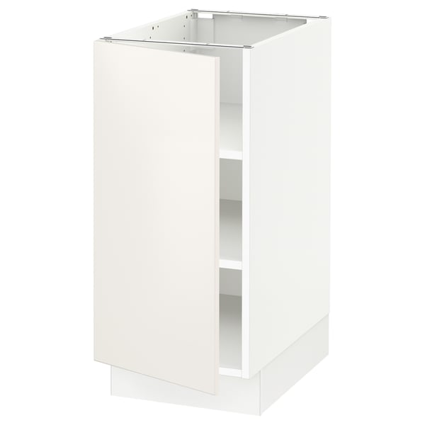 A white SEKTION kitchen cabinet with a single open door, featuring clean lines and adjustable shelves.