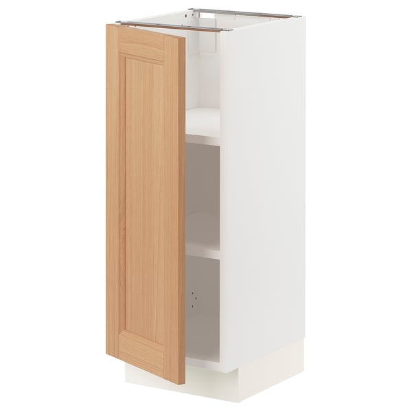 A SEKTION kitchen cabinet with a light oak door and white body, featuring an open design for storage.