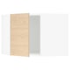 An open white kitchen cabinet with a light wooden door partially ajar.