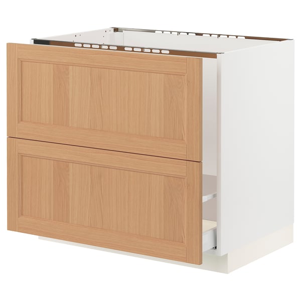 SEKTION kitchen cabinet with oak drawers and white base.