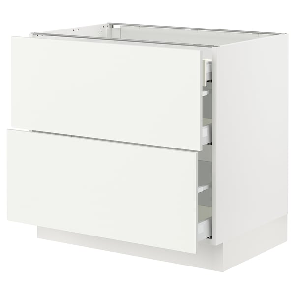 Displays an ikea SEKTION kitchen cabinet in white with drawers and a top shelf. The cabinet is rectangular with clean lines and a modern design.