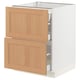 An open white SEKTION kitchen cabinet with two light oak drawers and a wooden panel door.
