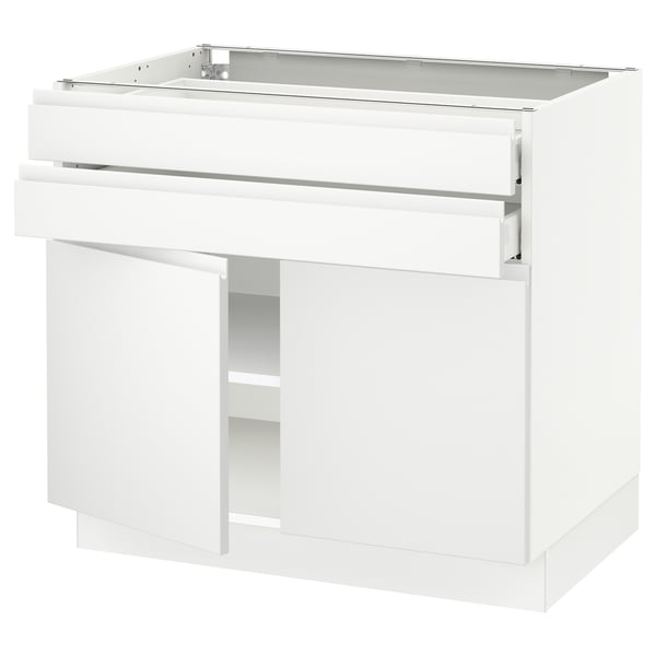 Modern white kitchen unit with sleek design and integrated handles.