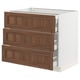 Modern kitchen cabinet, white base with three dark wooden drawers.