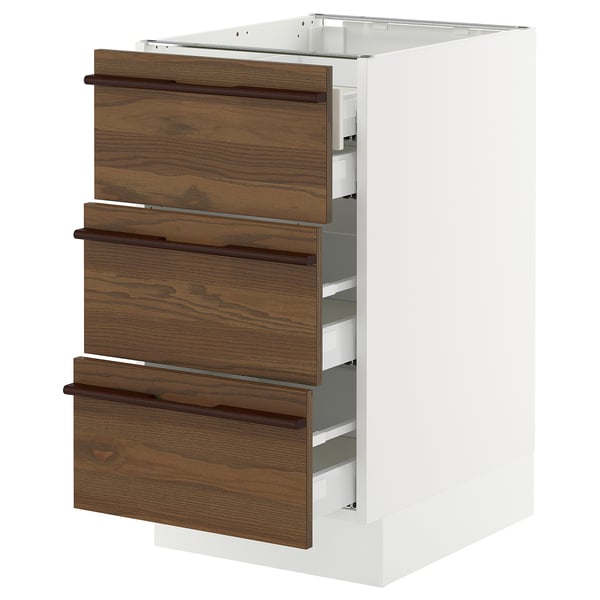 A SEKTION kitchen cabinet with dark brown stained ash veneer drawers and white base.