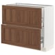 An ikea SEKTION kitchen cabinet with walnut-colored wooden panels and a white base. It has two drawers and a door.