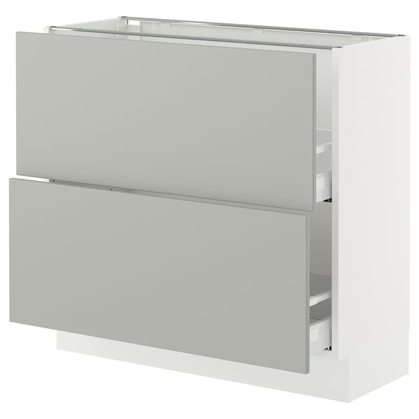 Modern white SEKTION kitchen cabinet with grey fronts, two drawers, and upper shelf.