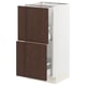 Modern oak-colored kitchen cabinet with white frame and pull-out shelves.