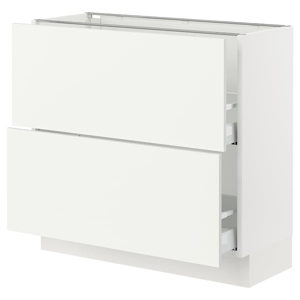 White kitchen cabinet, rectangular, with clean lines and modern design. Integrated drawers and smooth surfaces.