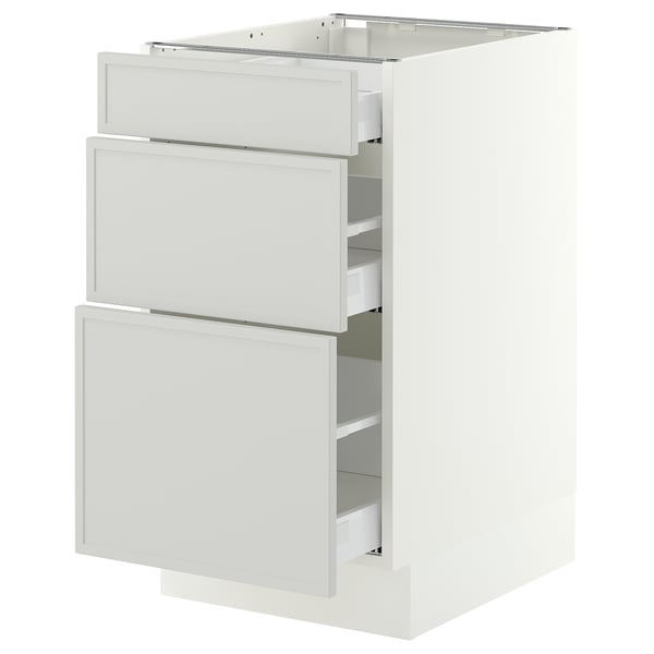 A white IKEA SEKTION kitchen base cabinet with three light grey drawers. Its modern, rectangular, and minimalist.