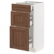 SEKTION kitchen cabinet with walnut wooden drawers and white frame.