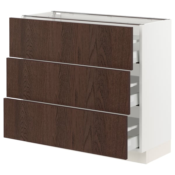 Dark wood drawers in white modern cabinet.