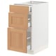 An ikea SEKTION white base cabinet with oak drawers and a door. It has a modern design with three wooden drawers and one wooden door.
