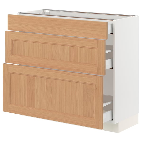 An ikea SEKTION kitchen cabinet with three wooden drawers in a light oak finish.