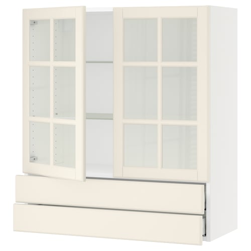 A white SEKTION kitchen cabinet with glass doors and drawers.