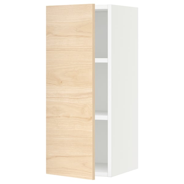 An open white cabinet with a light wooden door and a visible shelf inside.
