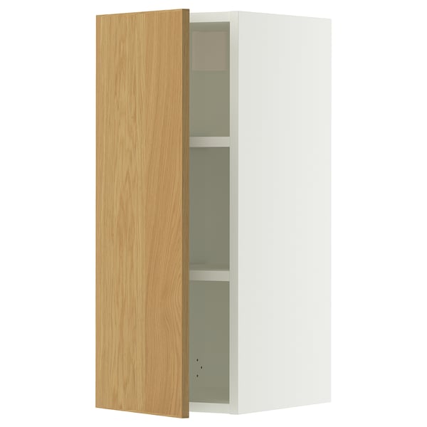 A white SEKTION wall cabinet with a light oak door, featuring an adjustable shelf inside.