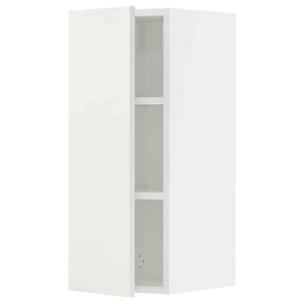A white SEKTION wall cabinet from ikea with shelves and a door.