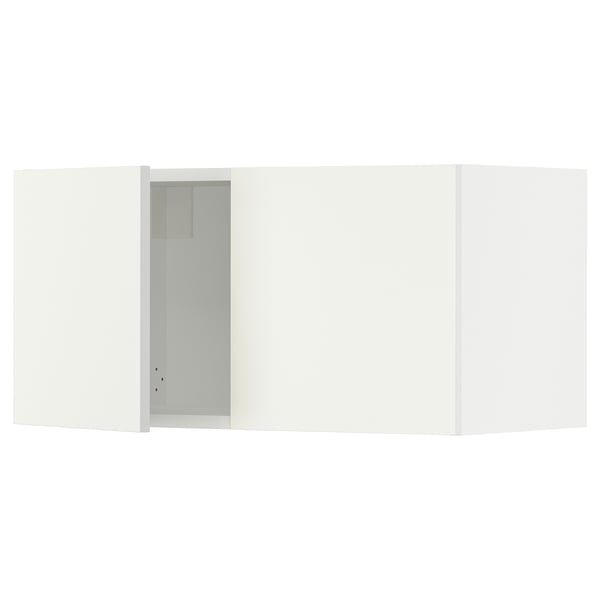 Depicts a white SEKTION kitchen cabinet with one open door revealing an empty interior.