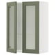 Green glass-door kitchen cabinet with white frame and adjustable shelves.