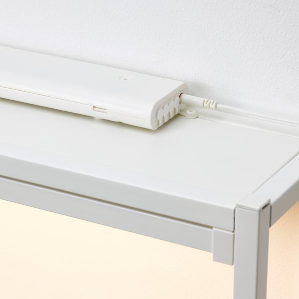 White ikea SILVERGLANS led driver, mounted on white shelf, powers smart lighting.