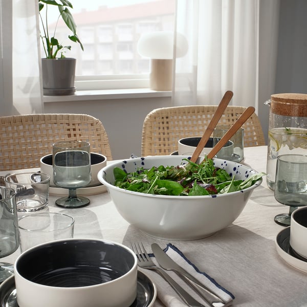 A table set with SILVERSIDA tableware, featuring a salad bowl, glasses, and cutlery.