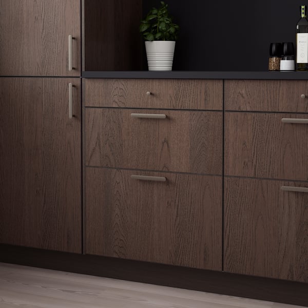 Brown SINARP kitchen cabinets with sleek handles and multiple drawers, plus a small plant on the countertop.
