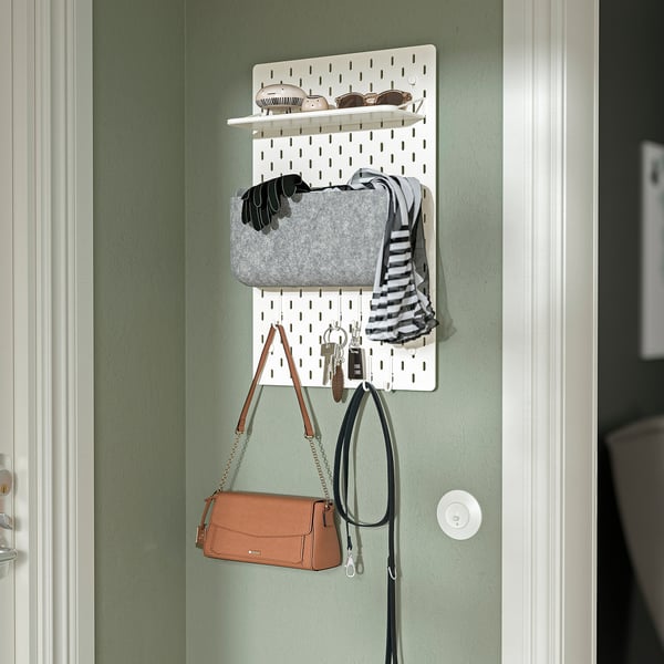 White pegboard, SKÅDIS, organising accessories and keys by the door.