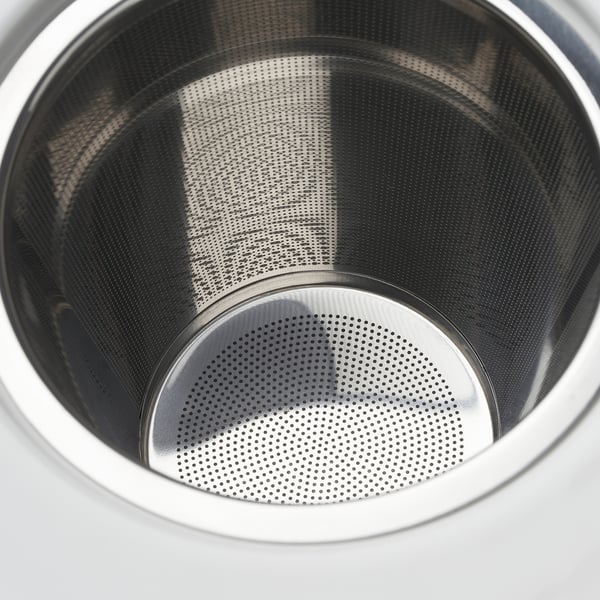 Stainless steel infuser of teapot, finely perforated, clean and polished.