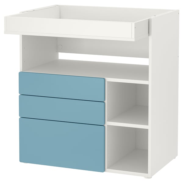 A white and blue ikea SMÅSTAD changing table with drawers. It has a flat top, three light blue drawers, and open compartments on the sides.