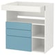 A white and blue ikea SMÅSTAD changing table with drawers. It has a flat top, three light blue drawers, and open compartments on the sides.