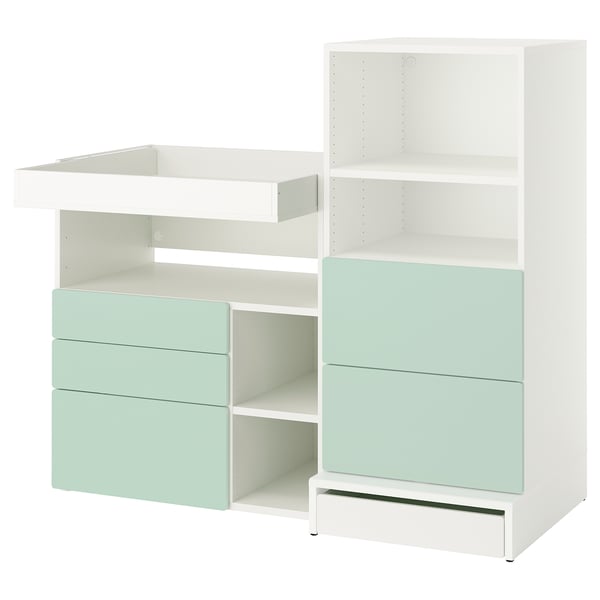 A white and light green SMÅSTAD changing table and storage unit combo. Modern, clean design with drawers and multiple shelves.