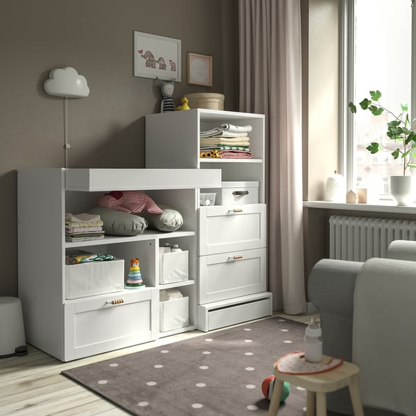 SMÅSTAD kids storage: shelves, drawers, changing table/desk. Sleek, light grey walls, white rug.