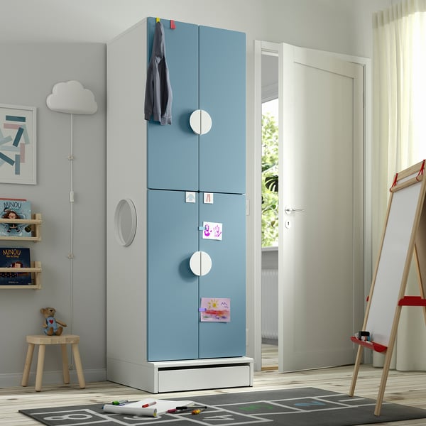 Blue SMÅSTAD kids wardrobe with white accents, tall and decorated with notes and cloth.