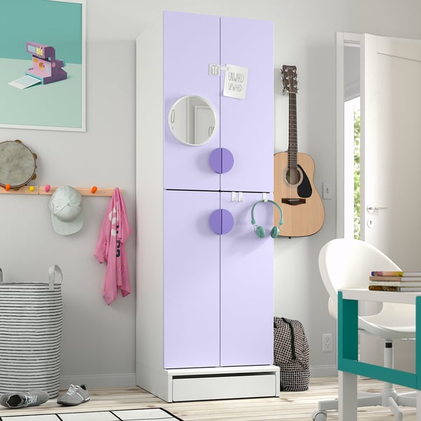 Childs room with lavender wardrobe, guitar, and desk.