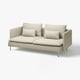 Modern beige l-shaped sofa with four pillows, sleek metal legs, and clean design.