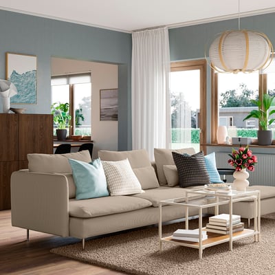 Stylish living room with SÖDERHAMN sofa, cushions, white coffee table, and hanging light fixture.