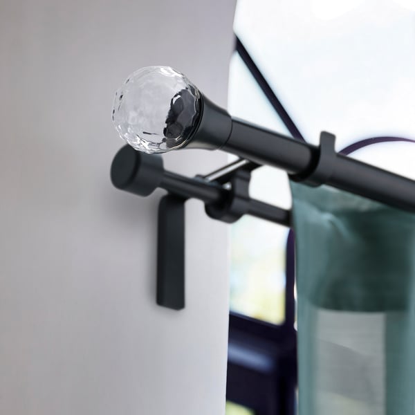SOLBLOMMOSSA black globe finial on curtain rod, small and sleek.