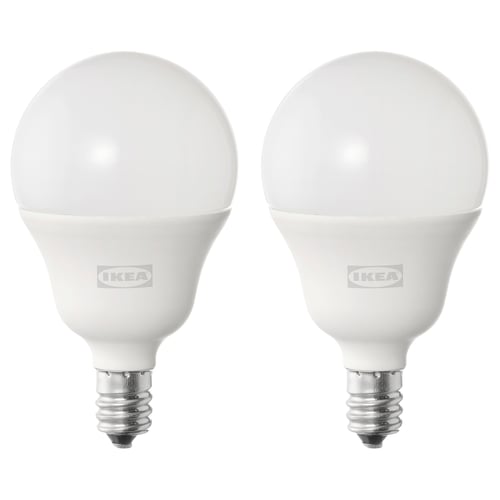 Two identical round ikea SOLHETTA white led light bulbs, standing upright, smooth surface, aluminum base.