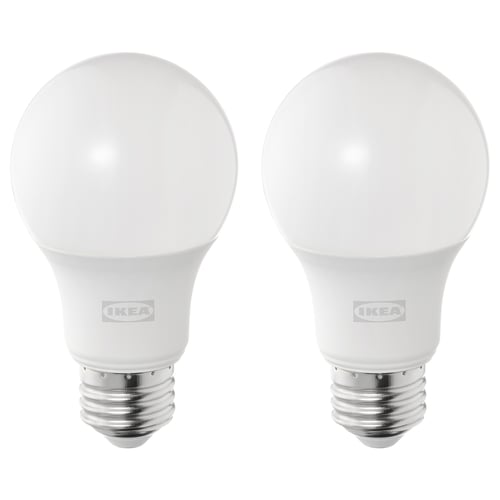 Two white, spherical led light bulbs by ikea with a metallic base, emitting a warm-white light.