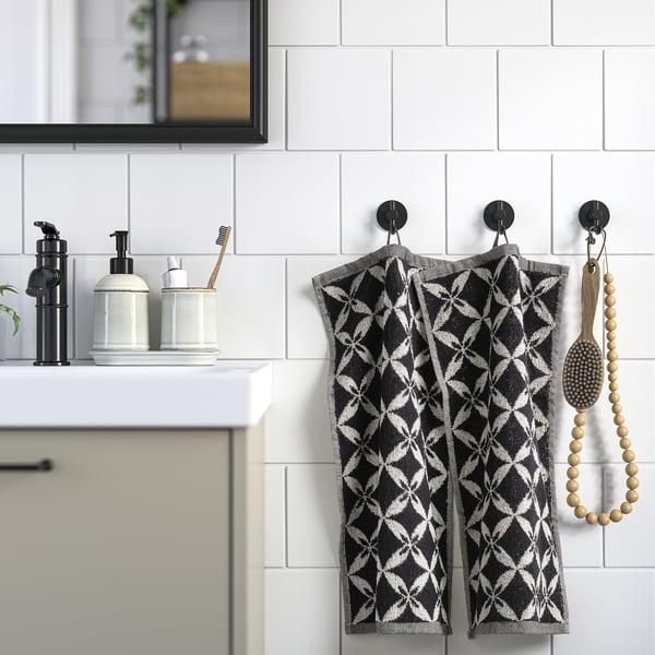 Black & white patterned towels with hooks in modern kitchen