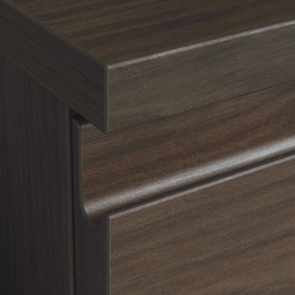 Dark wooden drawer close-up, showcasing sleek handles and grain texture.