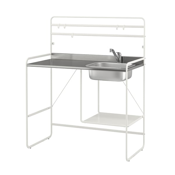 A white SUNNERSTA mini-kitchen with a stainless steel sink and shelf. The frame is metal with adjustable feet.
